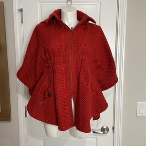 Rust orange colored zipper and hooded poncho/jacket.